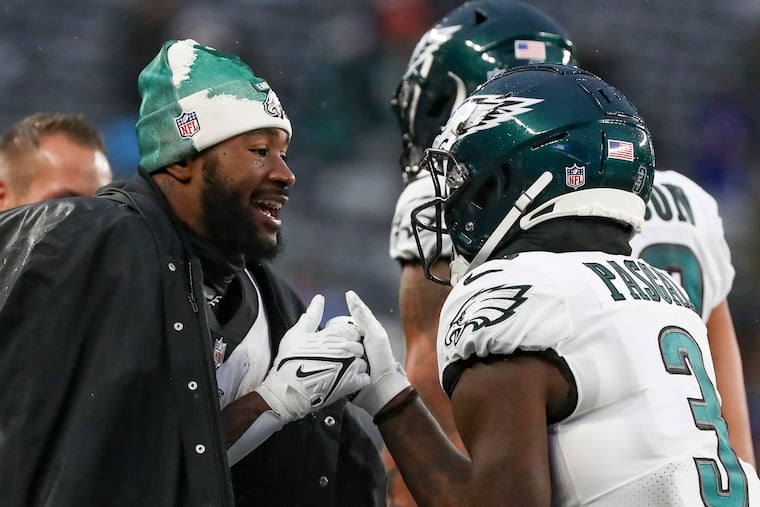Philadelphia Eagles running back Miles Sanders (left) and wide receiver Zach Pascal (3) have a thumb war on the sideline during last week's blowout win over the Giants.