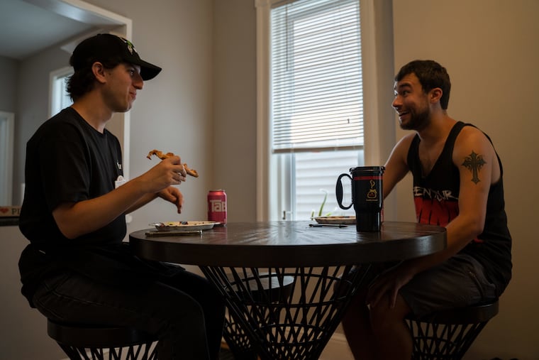 Michael Franolich, 25, (left) and Zack Pastore, 23, enjoy conversation while eating their pizza for lunch in Collingswood. Michael, who is on the autism spectrum, and Zack who was diagnosed with aspergers syndrome, have been placed in a job and home in Collingswood by the JEVS Independence Network.