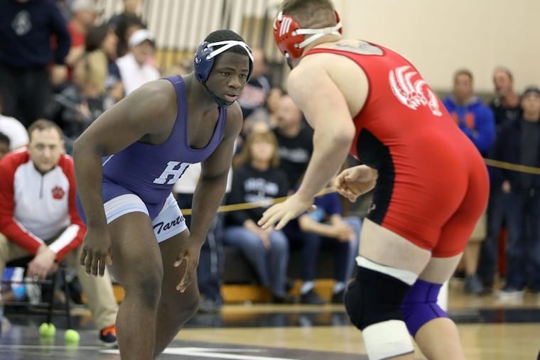 Highland’s Devon Starks left) wrestles Mike Mascioli of St. Joe’s last year.