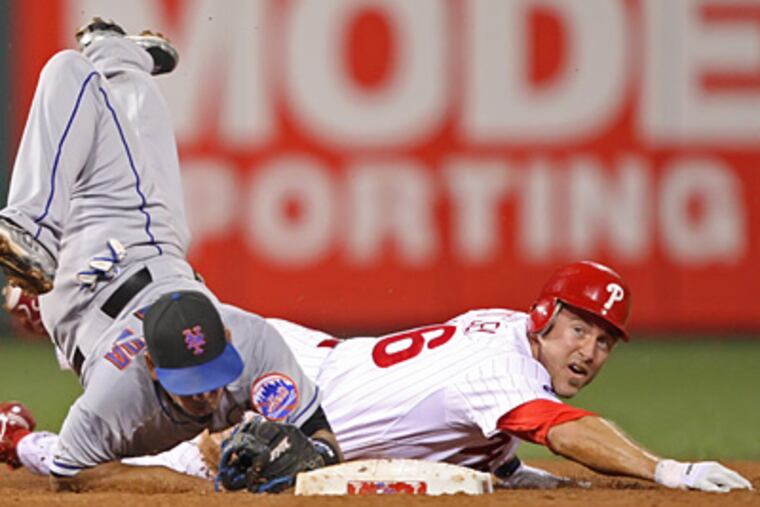 Chase Utley goes hard into second base trying to break up a double play against the Mets Friday. (Michael Bryant / Staff Photographer)