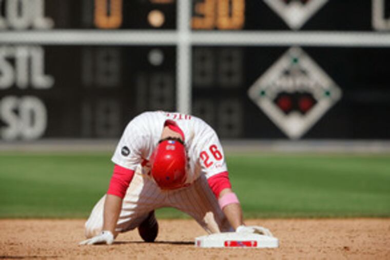 Second thought: The Phillies Chase Utley hangs his head as he kneels at second base after being tagged for the final out of a 4-1 loss to the Cubs while trying to stretch a single into a double.