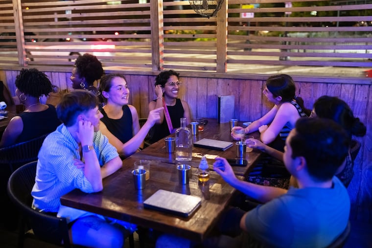 A group of friends have drinks outside Service Bar in Washington. MUST CREDIT: Craig Hudson/For The Washington Post