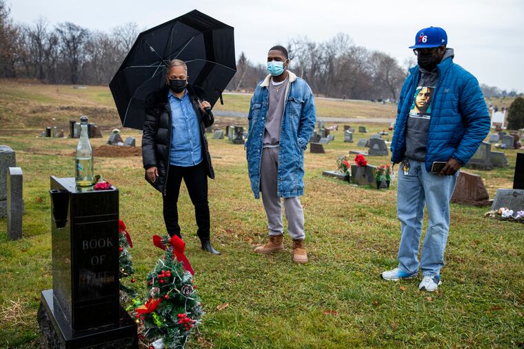 Mom Monique Irvis, father Eric Woods Sr., and little brother Dominique Woods, visit the grave of Eric Woods Jr., to celebrate his birthday on Christmas day. Eric was 19 when he was shot and killed in 2007. His family has been coming to Fernwood Cemetery ever since.