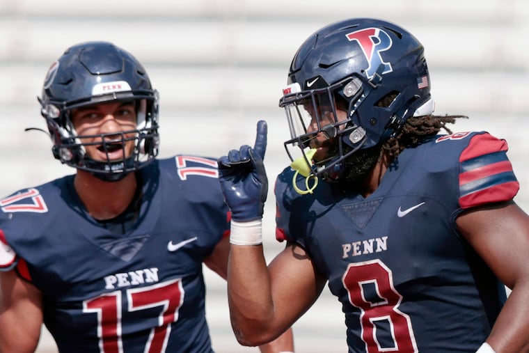 Penn running back Trey Flowers celebrates a touchdown earlier this season with Sterling Stokes (left).