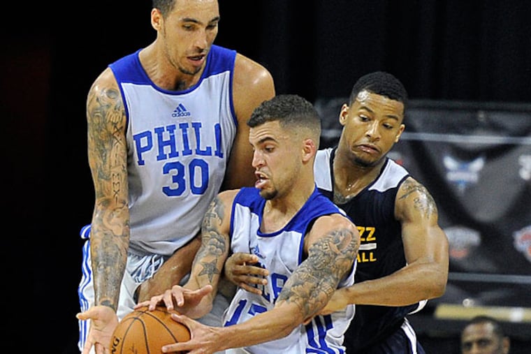 Scottie Wilbekin, center, and Drew Gordon (30) keep the ball away from Utah Jazz's Trey Burke during an NBA summer league basketball game on Saturday, July 12, 2014, in Las Vegas.