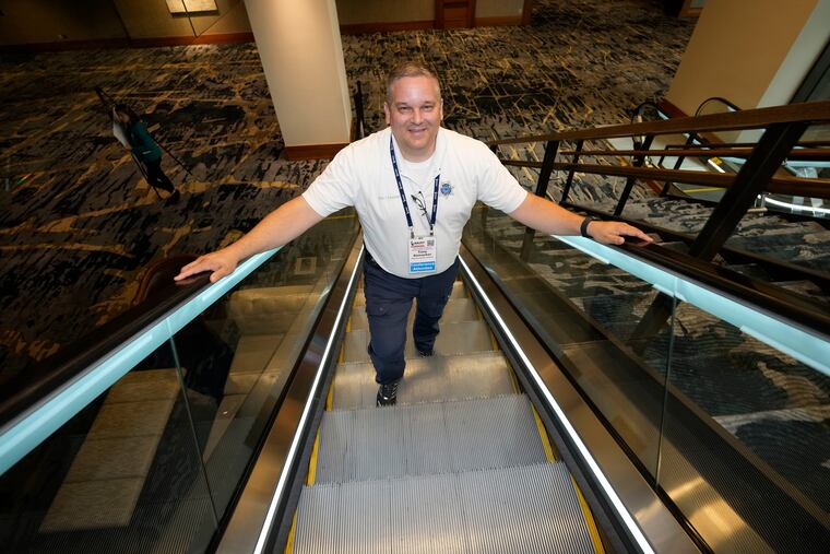 Student resource officer Tony Ramaeker, from Elkhorn, Neb., heads up an escalator while attending a convention, Tuesday, July 5, 2022, in Denver.