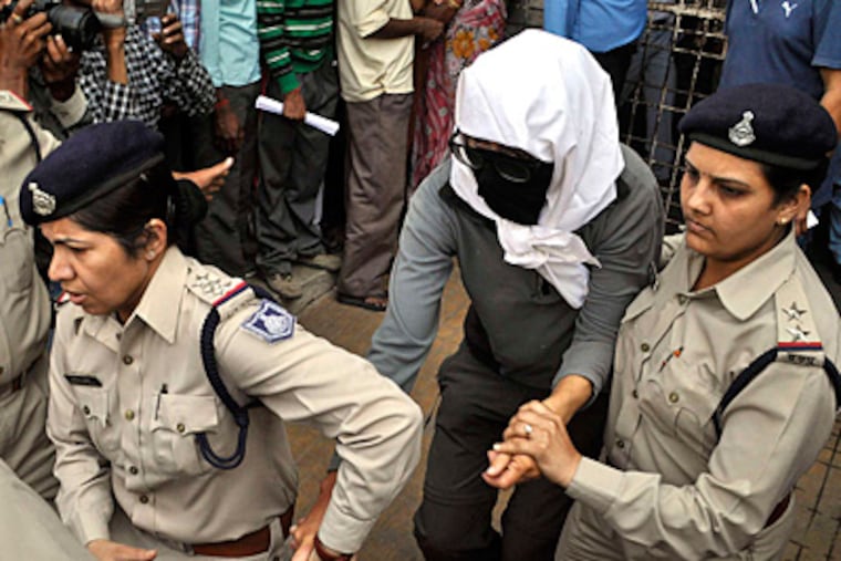Police escort the woman to a hospital in Gwalior. She had been on a cycling trip in central India with her husband when the attack occurred.