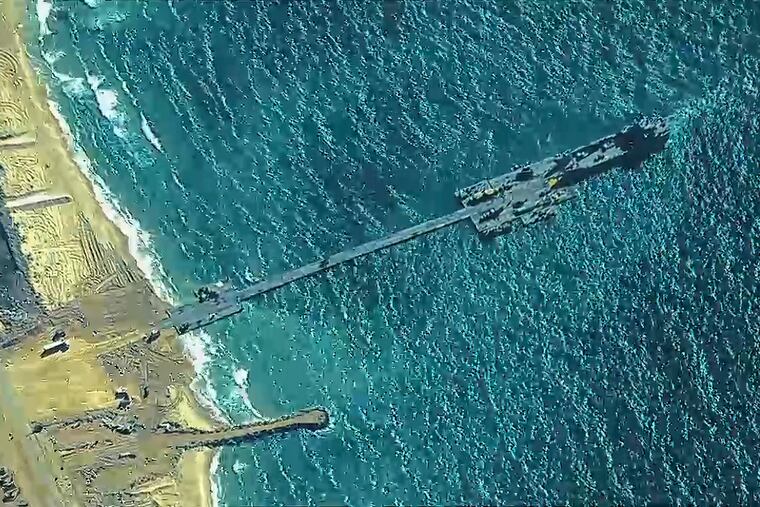 This image, provided by U.S. Central Command, shows U.S. and Israeli troops installing a temporary pier on the coast of the Gaza Strip to begin ferrying badly needed humanitarian aid into the besieged enclave.