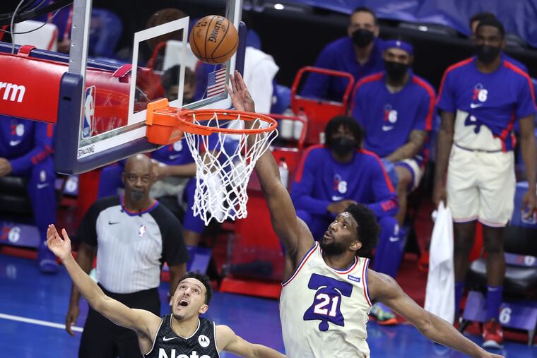 Landry Shamet (left) of the Nets shoots over his former teammate Joel Embiid during the second half of Wednesday's game at the Wells Fargo Center.