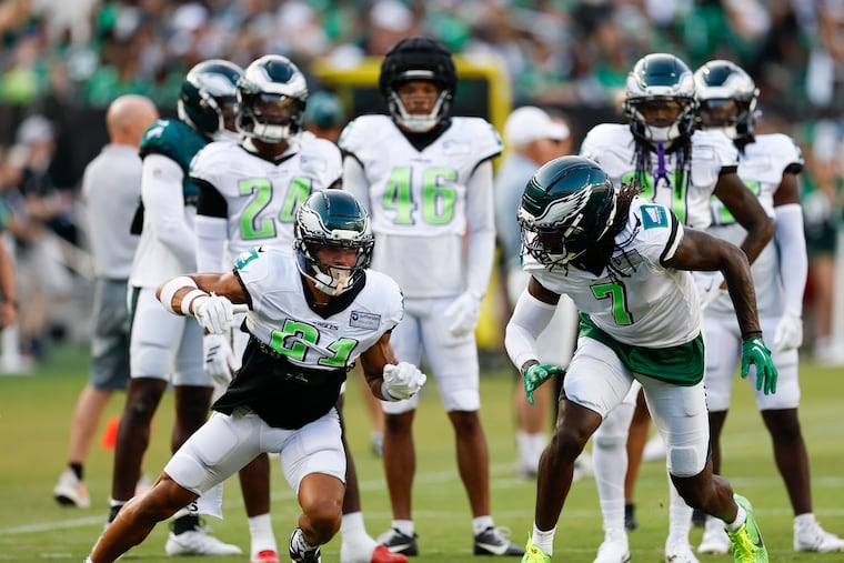 Eagles cornerback Kelee Ringo (right) and safety Sydney Brown run drills during an open practice at Lincoln Financial Field earlier this month.