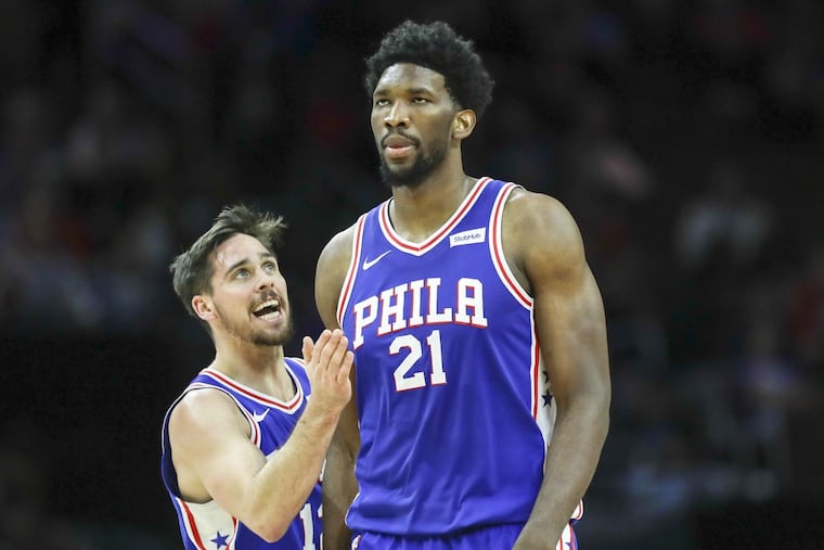 Sixers center Joel Embiid with teammate guard T.J. McConnell against the Utah Jazz on Monday, Nov. 20, 2017 in Philadelphia.