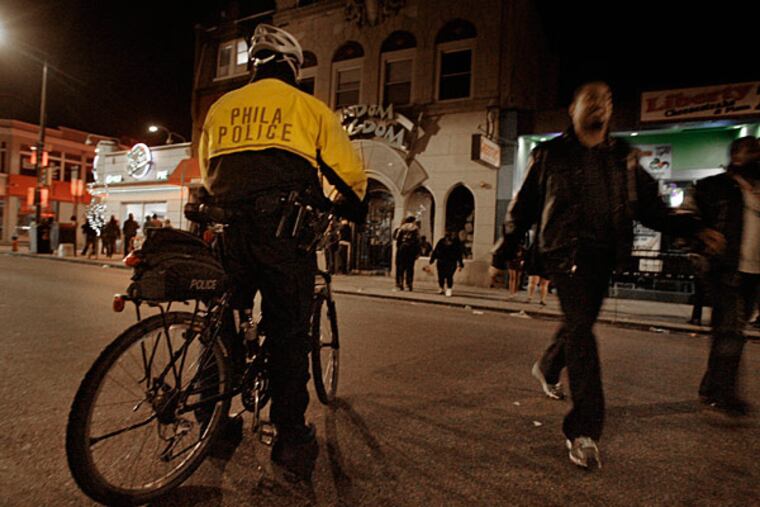 2:08 a.m. March 9, 2011: Philly police watch as people left Fat Tuesday after the Mardi Gras celebration on South Street. (Elizabeth Robertson/Staff)