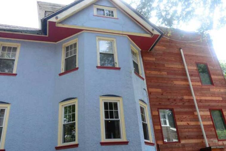 The house's back half was entirely rebuilt in natural stained redwood, contrasting the blue front. Red and blue are Teresa's favorite colors. VIVIANA PERNOT / Staff Photographer
