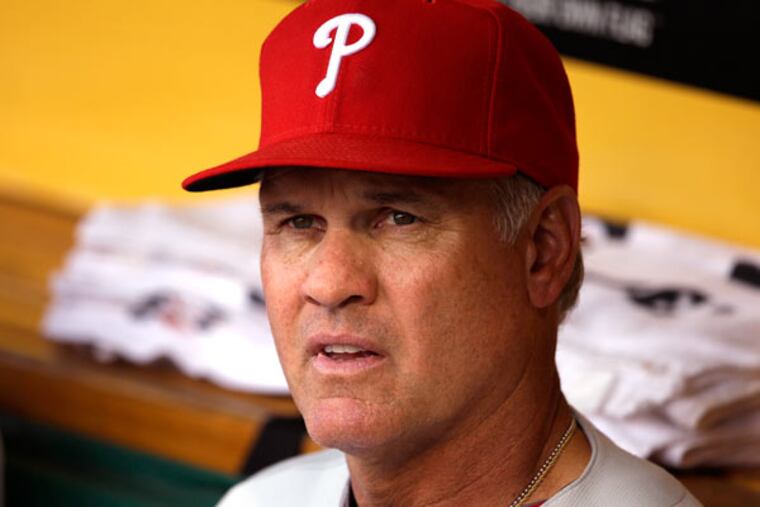 Phillies third base coach Ryne Sandberg (23) sits in the dugout before a baseball game against the Pirates in Pittsburgh Tuesday, July 2, 2013. The Phillies won 3-1. (Gene J. Puskar/AP)