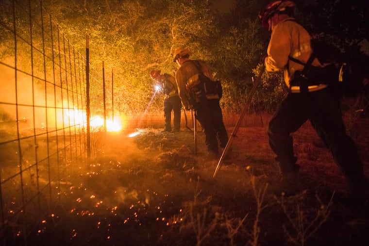 Firefighters from Brea, Calif., inspect and cut fireline on Aug. 1, 2018, as the Ranch Fire burns near Upper Lake, Calif. A day earlier, it and the River Fire totaled more than 74,000 acres. MUST CREDIT: Photo for The Washington Post by Stuart W. Palley. GETTY OUT