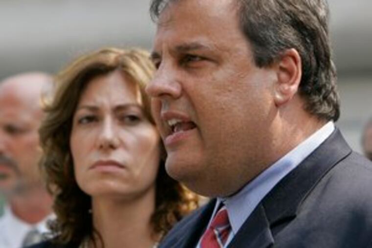 U.S. Attorney Christopher Christie, with Attorney General Anne Milgram, speaks to reporters outside the courthouse.