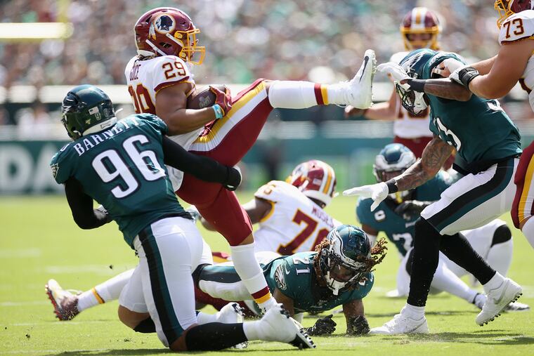 Eagles defensive end Derek Barnett (96) brings down Washington Redskins running back Derrius Guice (29).
