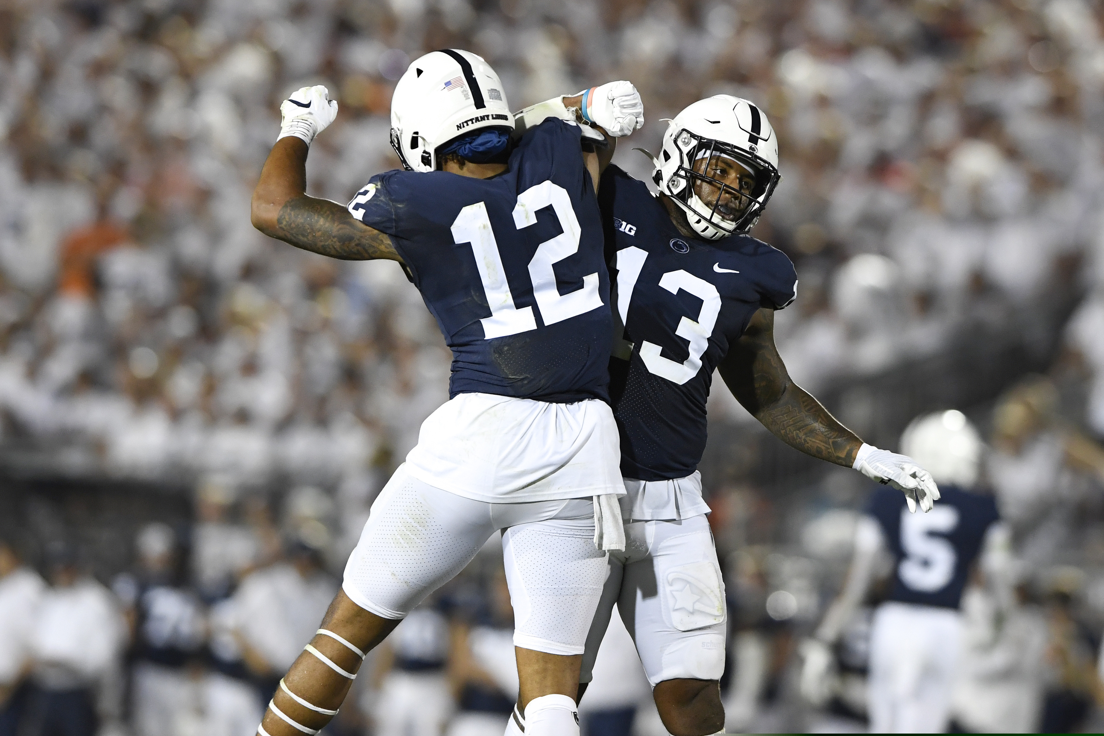 Penn State linebackers Brandon Smith (12) and Ellis Brooks (13) celebrate a stop against Auburn during an NCAA college football game in State College, Pa., on Saturday, Sept. 18, 2021.