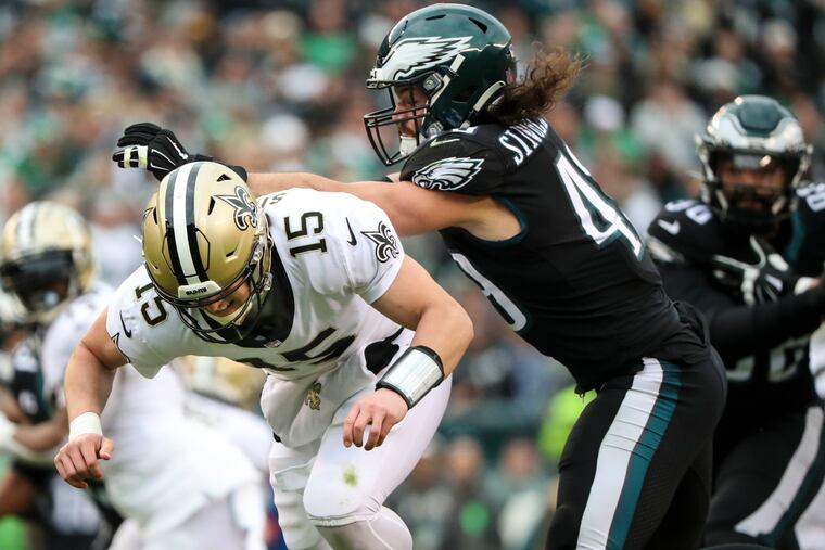 Philadelphia Eagles outside linebacker Alex Singleton (49) pushes New Orleans Saints quarterback Trevor Siemian (15) after he released the ball during the second quarter of the Philadelphia Eagles game against the New Orleans Saints at Lincoln Financial Field in Philadelphia on Sunday, Nov. 21, 2021.