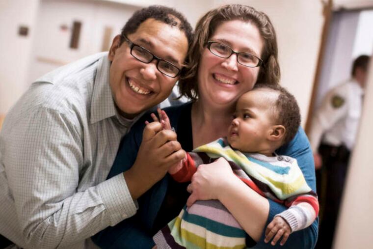 Rachel Blake and Rob Jefferson are delighted with the arrival of Eva Rebecca. She is, too. (Joel Knepper of J and A Photography)