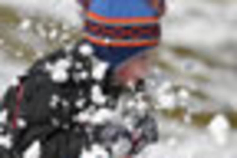Adam Hlinka, 9, of Lopatcong Township, goes through a ramp made of snow while sledding Sunday, Dec. 30, 2012 on a hill near Lopatcong Township Middle School. (AP Photo/The Express-Times, Matt Smith)