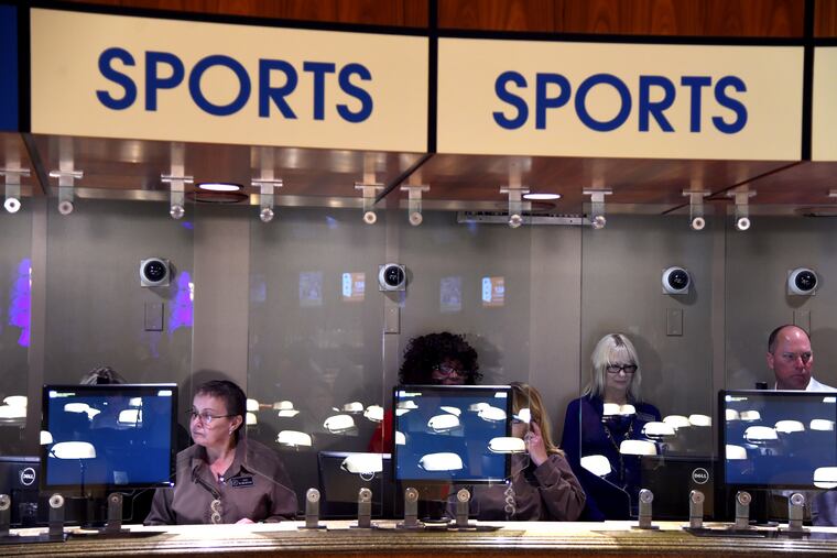 Sports book writer Tess Nelson (left) waits at the Borgata to take the first bets Thursday as the Atlantic City casino prepares to make the first sports bet at a New Jersey casino. TOM GRALISH / Staff Photographer