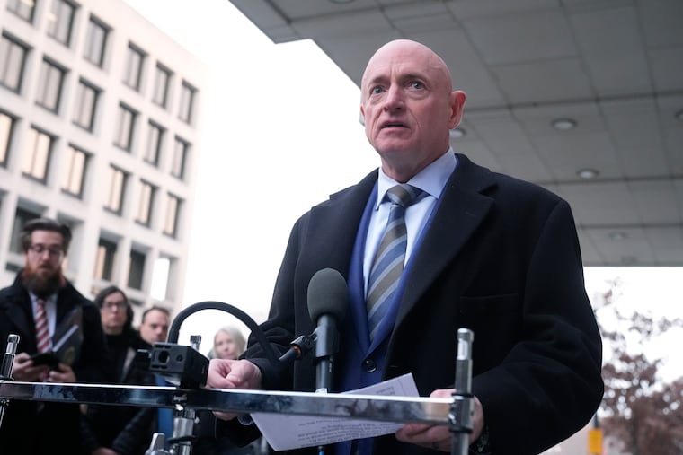 Sen. Mark Kelly, D-Ariz., speaks to reporters outside of federal court in Washington on Tuesday, Feb. 3.