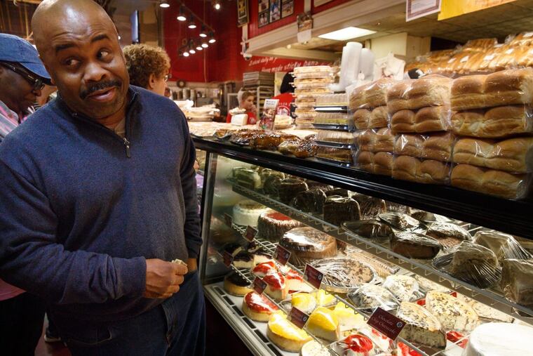 Benjamin Franklin waits in line at Beiler’s Bakery to order his favorite cheesecake, at Reading Terminal Market on the day before Thanksgiving.