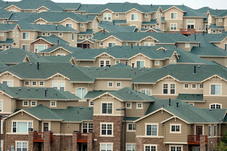 \The roofs of houses stack up on a hillside in a development in the east Denver suburb of Aurora, Colo., in 2006.