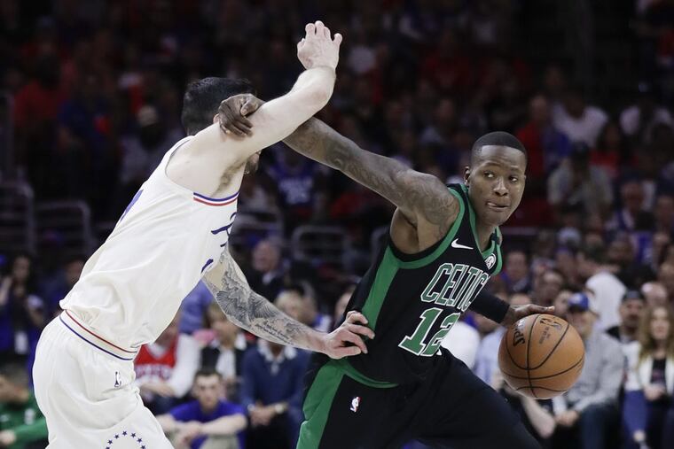 Celtics guard Terry Rozier commits a foul while trying to get by the Sixers’ JJ Redick during the second quarter of Game 4.