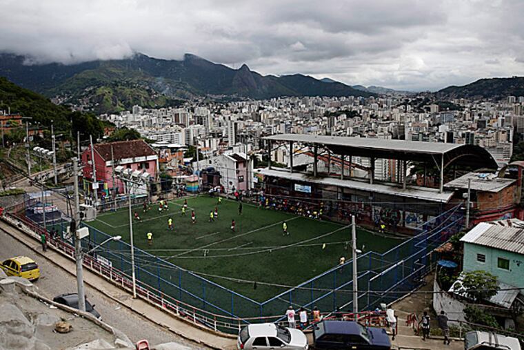 A view from the top of Salgueiro slum shows men playing soccer during the 2014 People’s Soccer Cup in Salgueiro slum, Rio de Janeiro, Brazil. (Hassan Ammar/AP)
