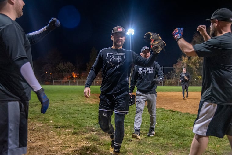 Will Ethington heads off the field with teammates at the end of an inning as he pitches in his softball game Thursday night, Nov. 3, 2022. One leg was an inch and a half shorter than the other as a result of the chemotherapy he had when he was diagnosed with T-cell lymphoma at age 3. He recently had magnetic limb lengthening surgery to correct the imbalance.