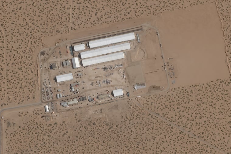 A satellite image taken six months ago shows the construction of large white tents for a new immigrant detention center at Fort Bliss, an Army base outside El Paso, Texas.