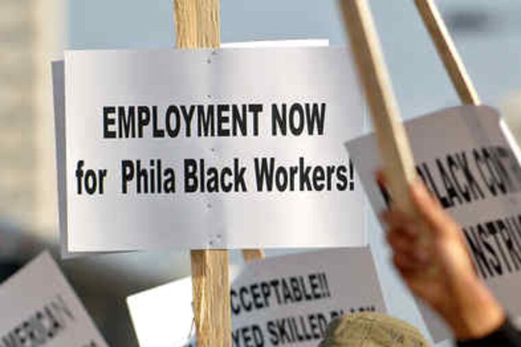 General contractor Dereck Jones pickets along North Broad Street near the Convention Center.