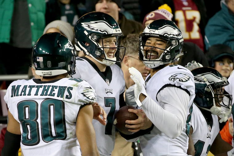 Eagles wide receiver Jordan Matthews (80), quarterback Nate Sudfeld (7), and tight end Richard Rodgers (82) celebrate after Sudfeld threw a pass for a touchdown in the fourth quarter of a game against the Washington Redskins at FedEx Field in Landover, Md., on Sunday, Dec. 30, 2018. The Eagles won 24-0.