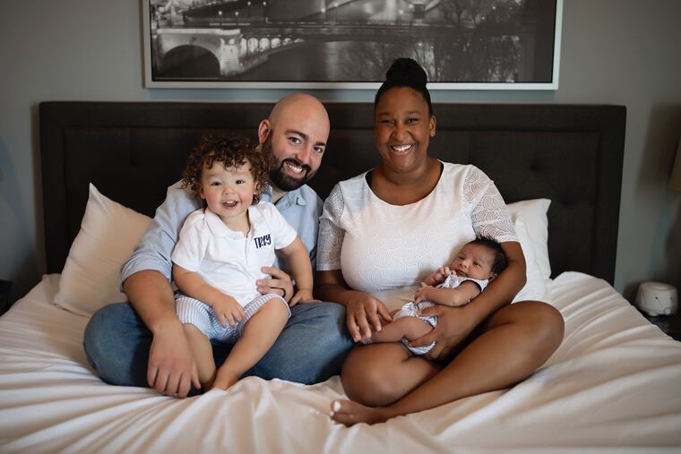 Ant (holding Trey) and Chrissy (holding newborn Teddy).