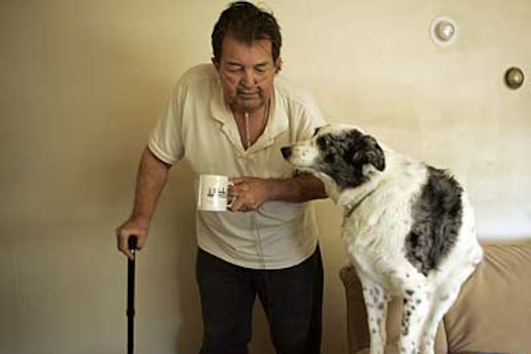 Richard Hershman, 62, of Northeast Philadelphia with his dog, Blue. He broke his arm in January; he couldn't get surgery until March. (MICHAEL PEREZ / Staff Photographer)