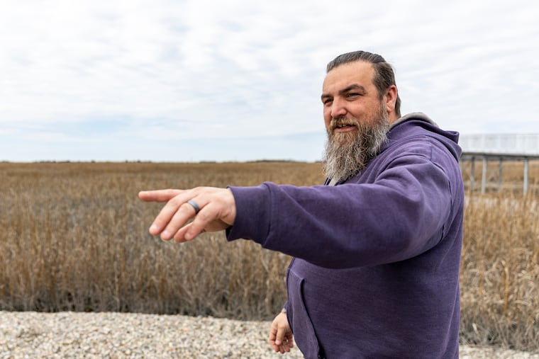 Shane Godshall, habitat restoration project manager for the American Littoral Society, points to where coir logs — made of coconut husks — are being used to raise Thompsons Beach marsh and prevent erosion near the Delaware Bay in Cumberland County.