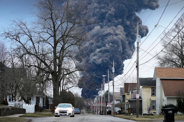 A black plume rises over East Palestine, Ohio, as a result of a controlled detonation of a portion of the derailed Norfolk Southern trains in 2023. Federal investigators said on Feb. 7 that they will determine the cause of last year’s fiery Norfolk Southern derailment in eastern Ohio at a hearing in East Palestine this June.