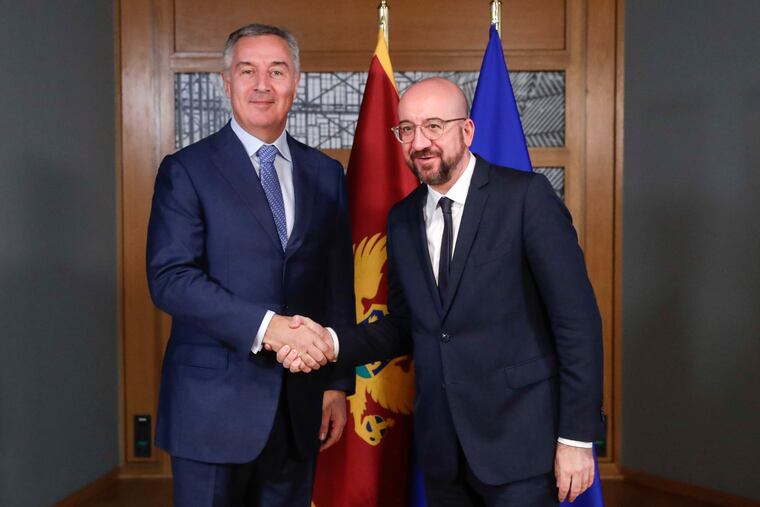 Montenegro's President Milo Dukanovic, left, is welcomed by European Council President Charles Michel prior to a meeting at the Europa building in Brussels, Monday, Feb. 17, 2020.