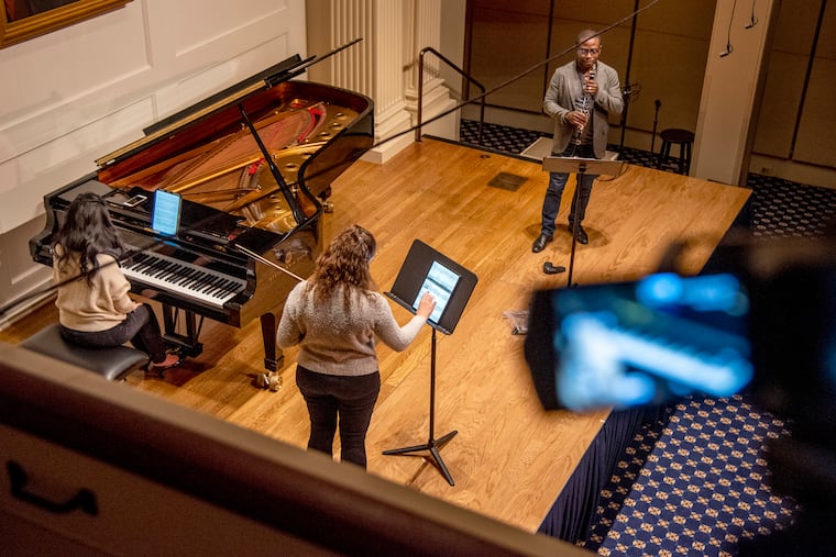 Philadelphia Chamber Music Society musicians rehearse in the American Philosophical Society's Benjamin Franklin Hall Feb. 10, 2021 before their live-streamed concert. From left: pianist Gloria Chien, violist Milena Pajaro-van de Stadt, and clarinetist Anthony McGill.