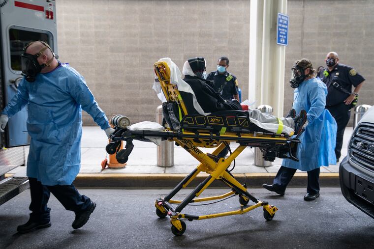 A woman is brought to an ambulance on May 26. Stroke and heart cases plummeted during the pandemic, and hospitals worry about long-term consequences for patients who delayed care.
