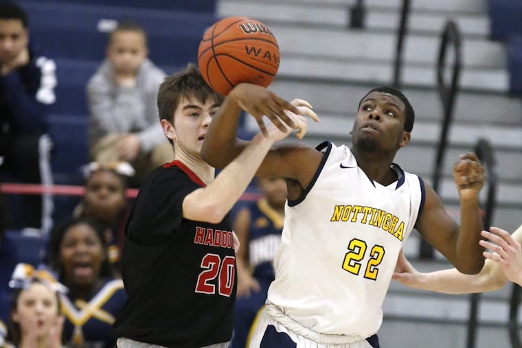 Will Bond, left, of Haddonfield and Deonte West of Nottingham battle for a rebound.