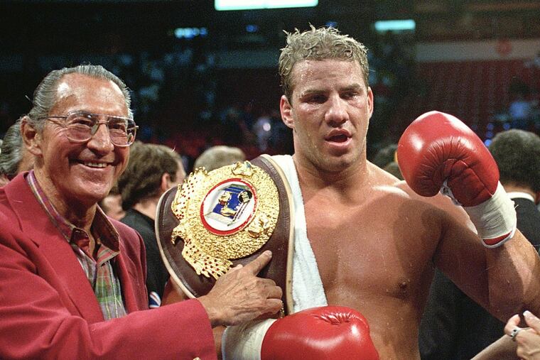 In this June 7, 1993 file photo, newly crowned WBO heavyweight champion Tommy Morrison receives his championship belt after defeating George Foreman in Las Vegas, Nev. ()
