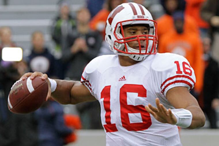 Russell Wilson used his last year of eligibility at Wisconsin after graduating from North Carolina State (Seth Perlman/AP Photo)