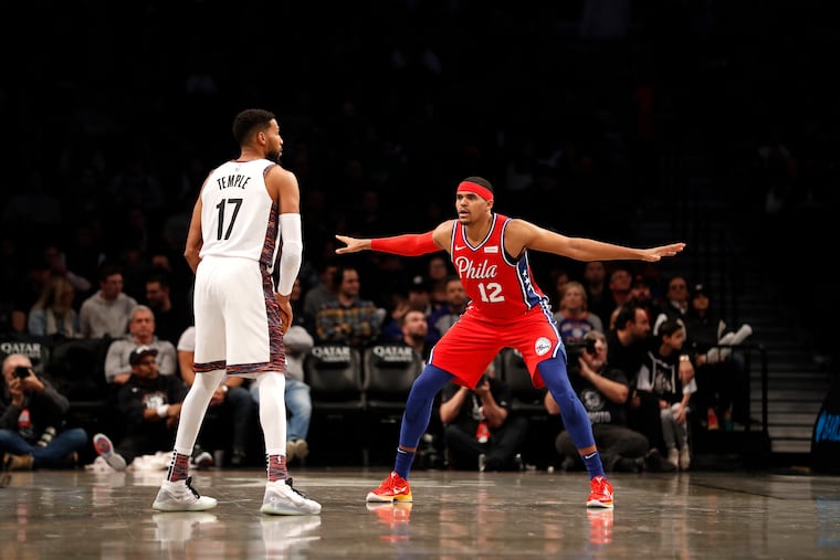 Sixers forward Tobias Harris (12) defends against Nets guard Garrett Temple (17) during the third quarter.