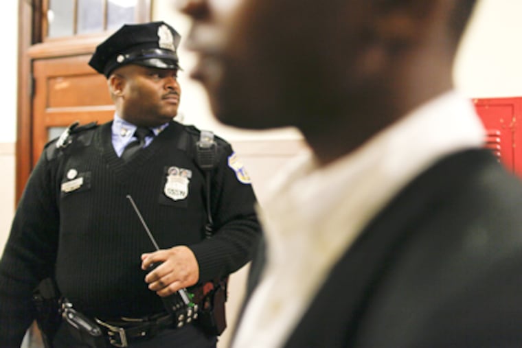 Officer Andrew G. Prosser patrols a hallway at Overbrook High. (Michael S. Wirtz / Staff Photographer)