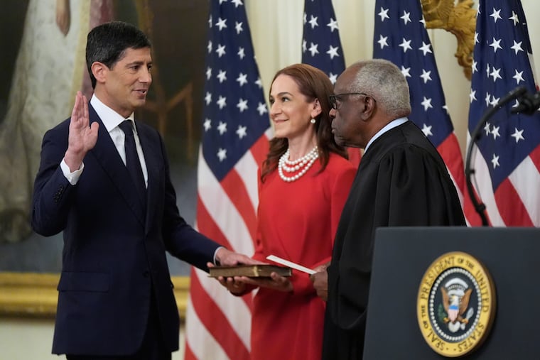 Supreme Court Justice Clarence Thomas administers the oath during the swearing in of Kevin Warsh, left, as Chairman of the Federal Reserve in the East Room of the White House, Friday, May 22, 2026, in Washington, as Warsh's wife Jane Lauder, looks on.