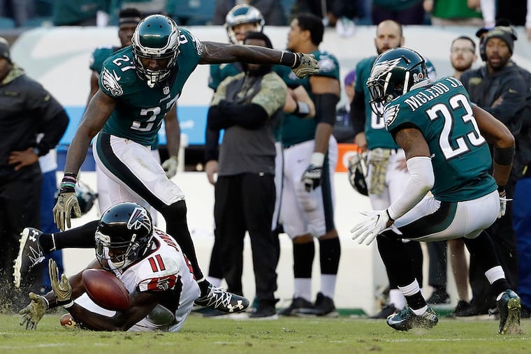 Atlanta Falcons' Julio Jones (11) cannot catch a pass as Philadelphia Eagles' Malcolm Jenkins (27) and Rodney McLeod (23) defend during the second half of an NFL football game, Sunday, Nov. 13, 2016, in Philadelphia.