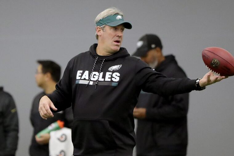Philadelphia Eagles head coach Doug Pederson plays with a football during Eagles practice in Philadelphia, PA on January 10, 2018. The Eagles are preparing for the playoff game against the Falcons. DAVID MAIALETTI / Staff Photographer